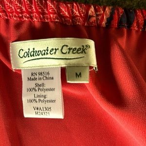 Skirt scalloped at bottom. 30 in length and 35 at tip of scallop at bottom.